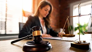 Attorney working with gavel and scales of justice