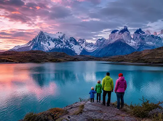 Family looking out over a Patagonian lake at sunset
